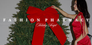 Woman in a red dress standing next to a large Christmas tree with a red bow, with 'Fashion Pharmacy' branding.