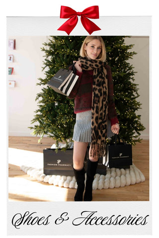 Woman holding shopping bags with a Christmas tree in the background, featuring 'Shoes & Accessories' text.